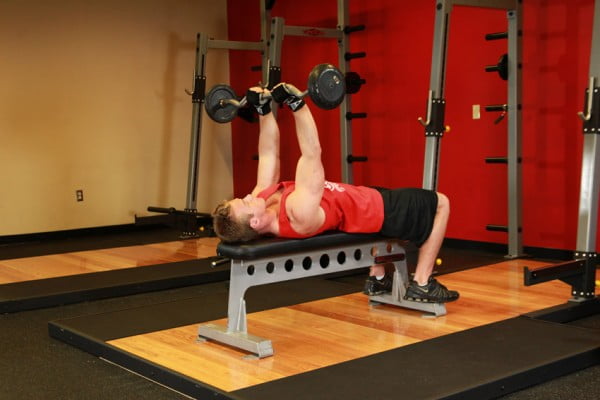 The bench press with a close grip by barbells while lying on a settle