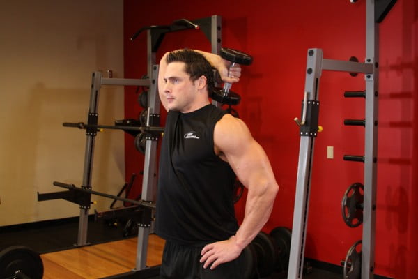 The extension of the one arm back with a dumbbell on the slope